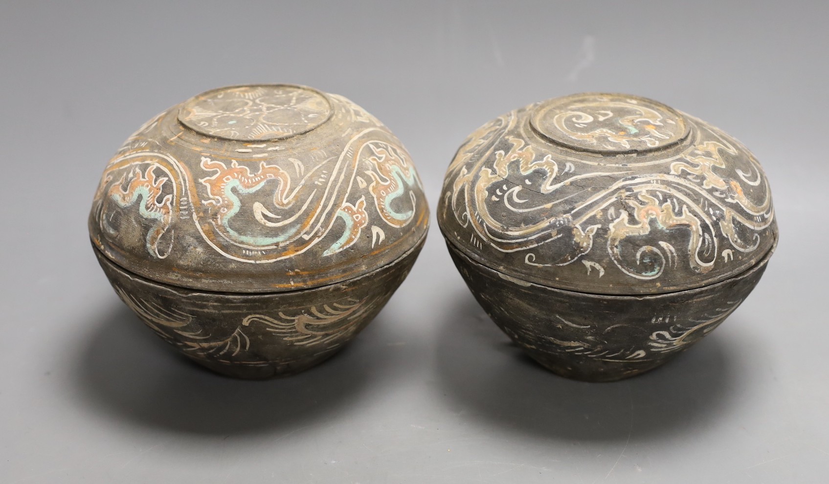 Two Chinese pigment painted grey pottery boxes and covers, Han dynasty (200BCE - 220CE), 12cm high